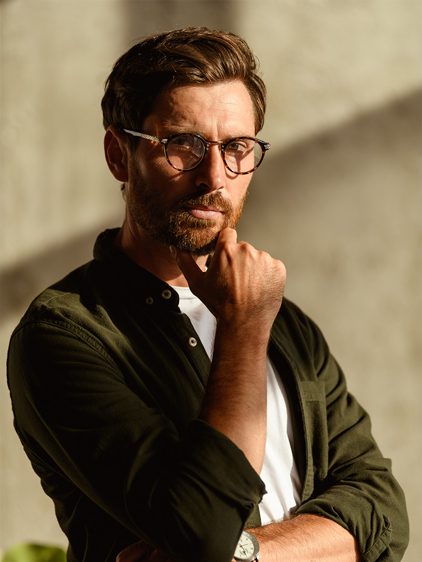 Thoughtful bearded man wearing glasses and olive green cardigan in natural window light - Elevated psa in Clifton, NJ